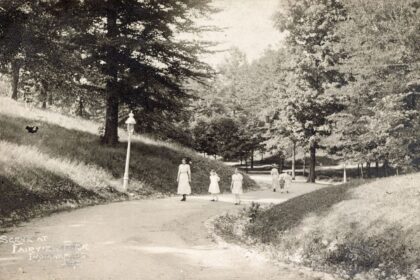 people walking along a park path in the morning