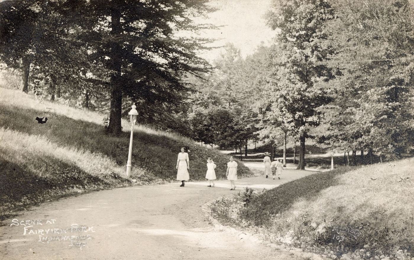 people walking along a park path in the morning